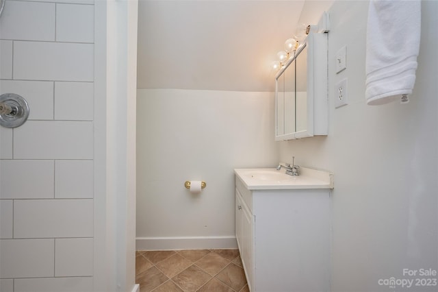 bathroom with walk in shower, vanity, and tile patterned floors