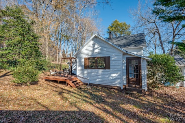 view of home's exterior with a lawn and a wooden deck