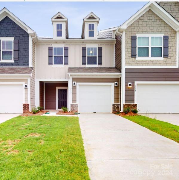 view of front of property with a front lawn and a garage