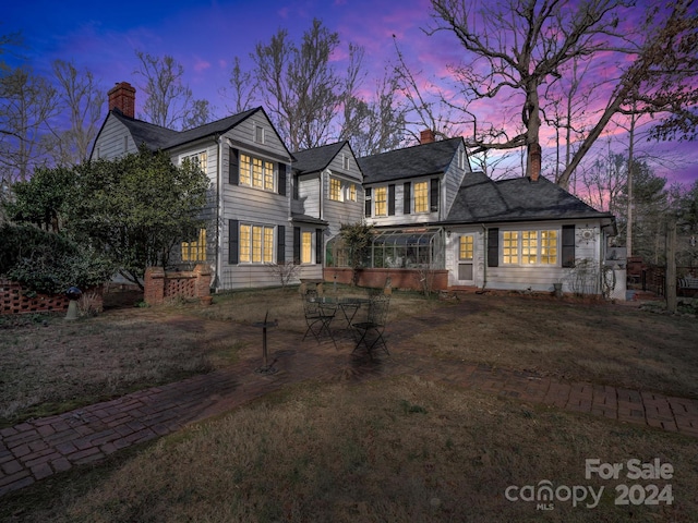 view of front of property featuring a sunroom