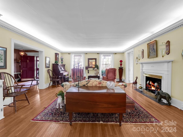 living room featuring ornamental molding and light hardwood / wood-style floors