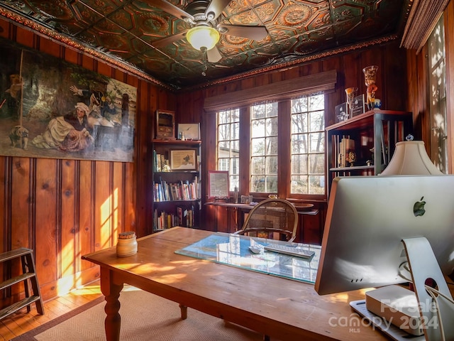 office space with ceiling fan, wooden walls, and wood-type flooring