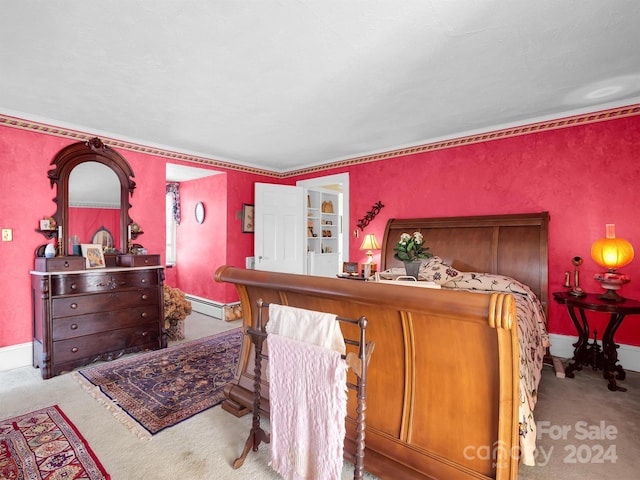 bedroom with a baseboard heating unit, indoor bar, and carpet floors