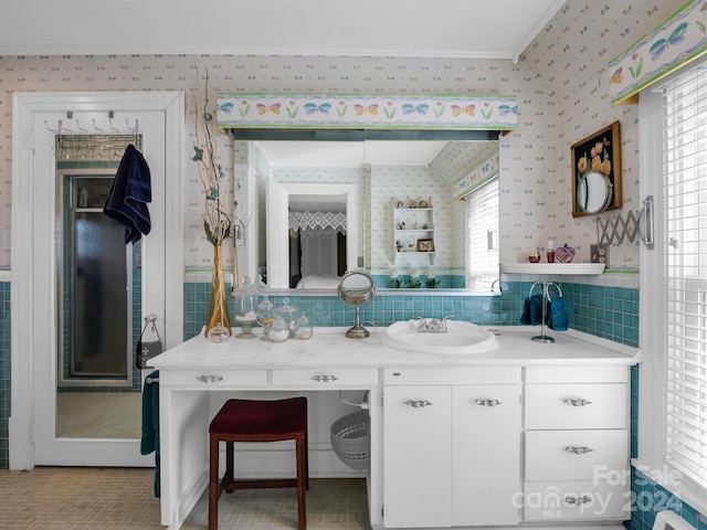 bathroom with vanity, ornamental molding, and tasteful backsplash