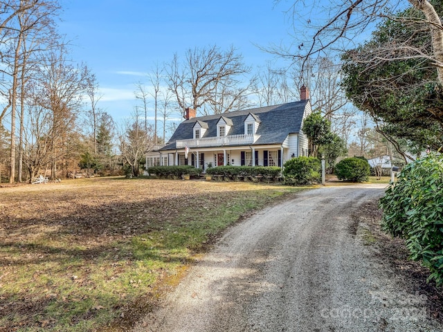 new england style home with a porch