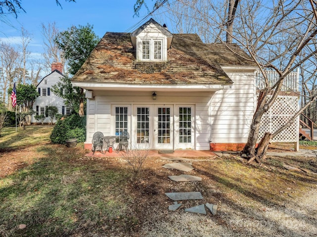 rear view of property with a patio area and french doors