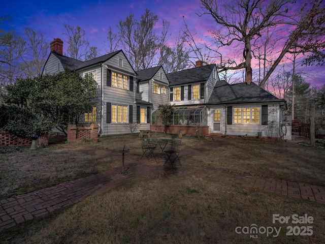 429 S Ridgecrest Ave, Rutherfordton, NC 28139 - view of front of home with a front lawn, a chimney, and a sunroom