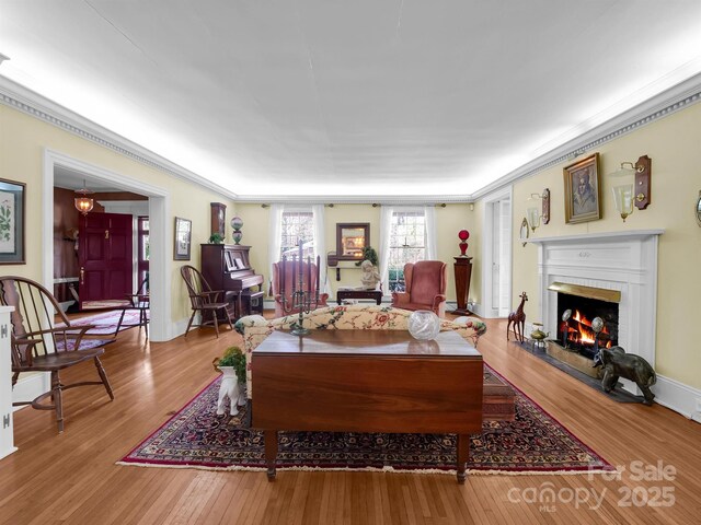 429 S Ridgecrest Ave, Rutherfordton, NC 28139 - living room with baseboards, ornamental molding, a lit fireplace, and wood finished floors