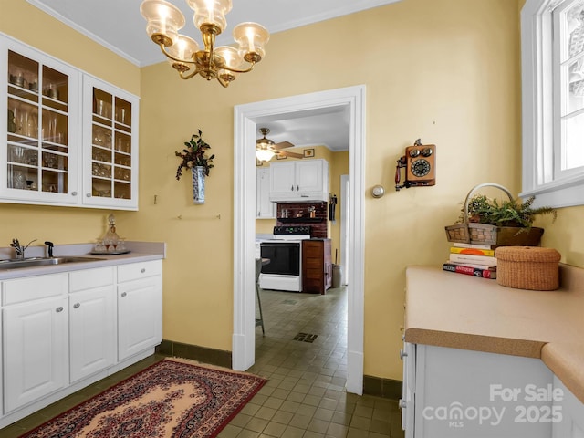 429 S Ridgecrest Ave, Rutherfordton, NC 28139 - kitchen with baseboards, white electric range oven, an inviting chandelier, and white cabinetry