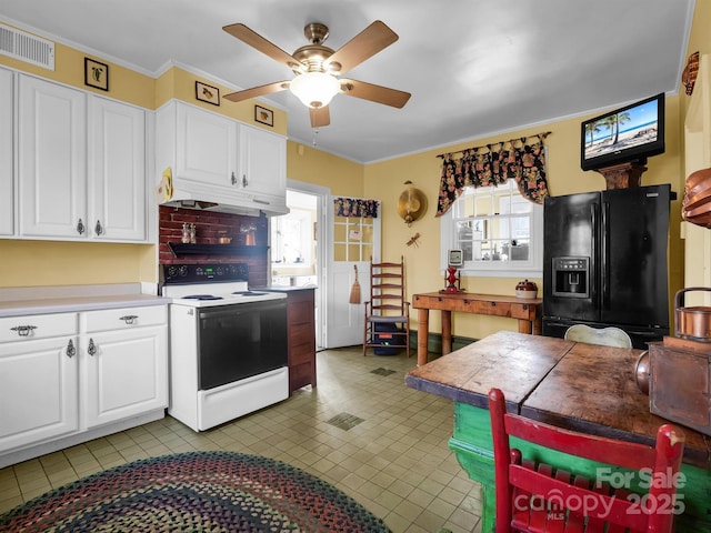 429 S Ridgecrest Ave, Rutherfordton, NC 28139 - kitchen featuring white electric stove, a healthy amount of sunlight, a ceiling fan, black fridge with ice dispenser, and white cabinetry