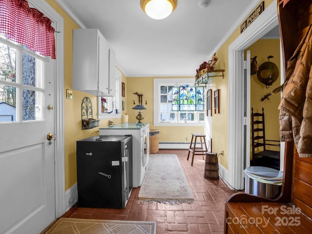 429 S Ridgecrest Ave, Rutherfordton, NC 28139 - kitchen featuring a baseboard heating unit, brick floor, washing machine and dryer, and a healthy amount of sunlight