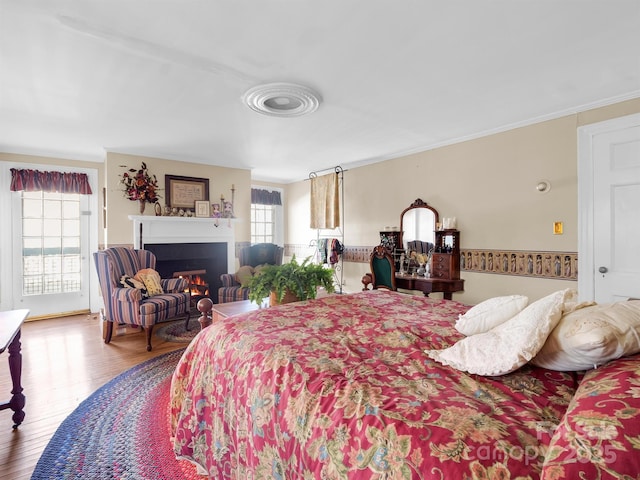 429 S Ridgecrest Ave, Rutherfordton, NC 28139 - bedroom featuring wood finished floors, ornamental molding, and a lit fireplace