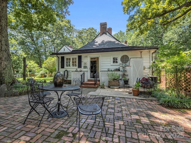 429 S Ridgecrest Ave, Rutherfordton, NC 28139 - rear view of property featuring a chimney and a patio