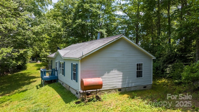 view of side of property with a yard