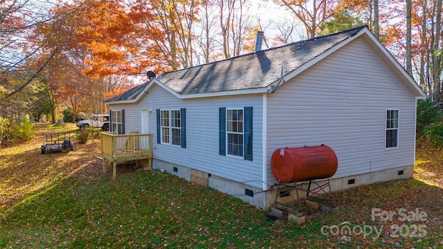 view of side of home with a lawn