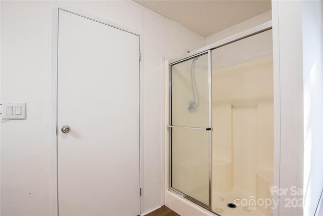 bathroom with a shower with shower door