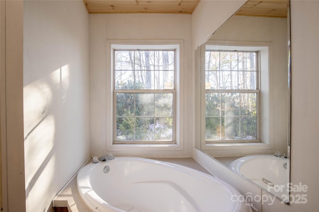 bathroom featuring a tub and wood ceiling