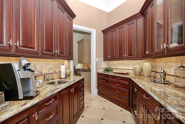 kitchen featuring backsplash, sink, and light tile floors