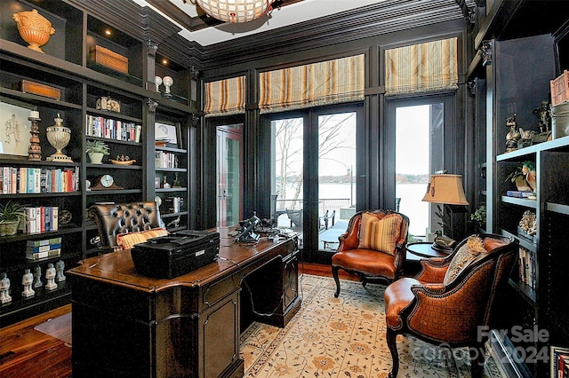 office space featuring light hardwood / wood-style floors, built in shelves, and ornamental molding