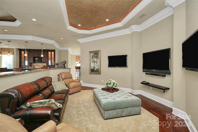 living room featuring ornamental molding and a tray ceiling