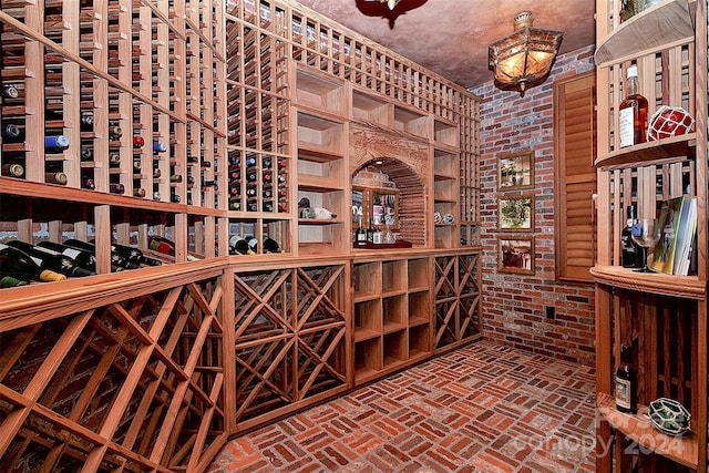 wine room featuring brick wall