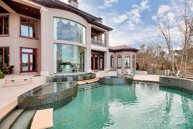 view of swimming pool with an outdoor kitchen and a patio area