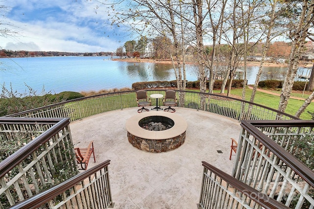 view of patio / terrace featuring a water view and a fire pit