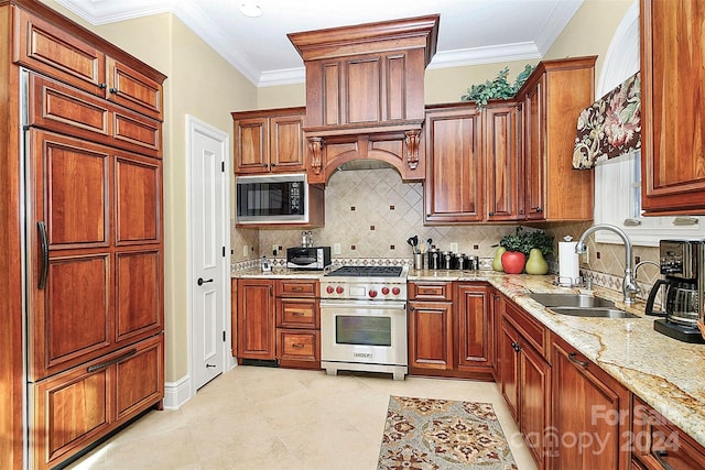 kitchen with backsplash, sink, premium range hood, light stone counters, and built in appliances