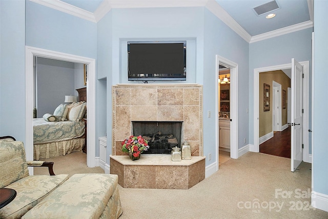 living room with light colored carpet, ornamental molding, and a tiled fireplace