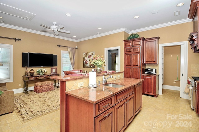 kitchen featuring ceiling fan, sink, light tile floors, a healthy amount of sunlight, and light stone countertops