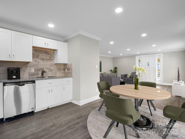 kitchen with light stone countertops, dark wood-type flooring, white cabinetry, sink, and stainless steel dishwasher