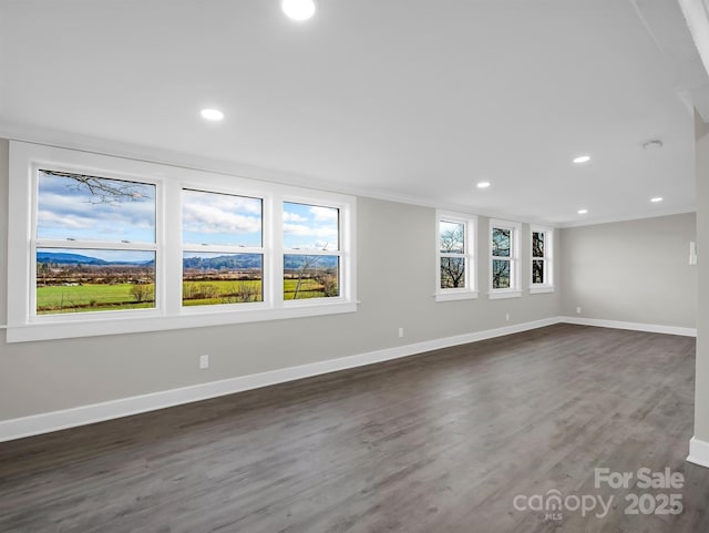 spare room featuring dark hardwood / wood-style floors and ornamental molding