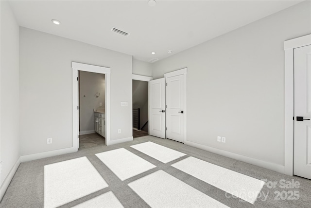 1428 Hamilton St Unit 13, Charlotte, NC 28206 - unfurnished bedroom featuring visible vents, recessed lighting, connected bathroom, baseboards, and light colored carpet