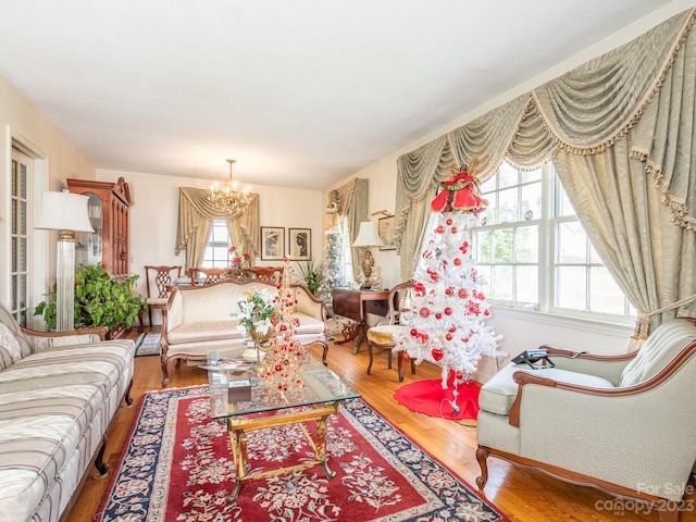 living room featuring a notable chandelier and hardwood / wood-style flooring