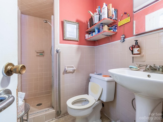 bathroom featuring backsplash, tile patterned floors, tile walls, toilet, and a shower with door