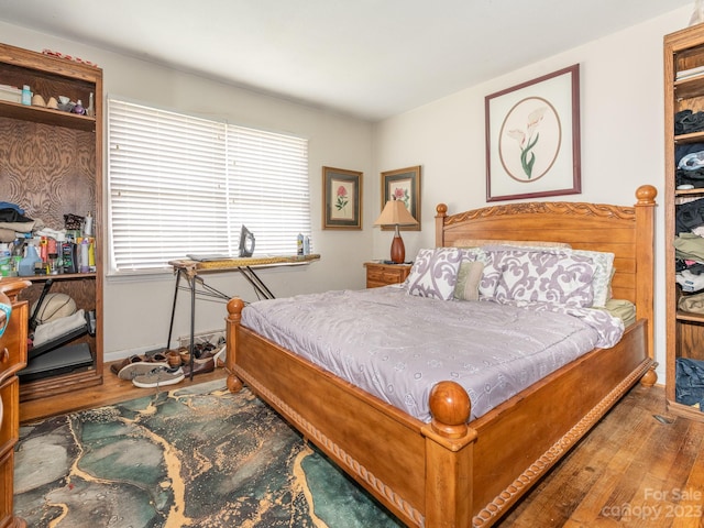 bedroom featuring multiple windows and hardwood / wood-style floors