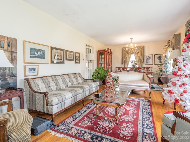 living room with an inviting chandelier and light wood-type flooring