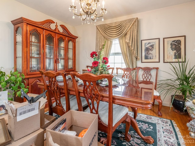 dining space with an inviting chandelier and hardwood / wood-style flooring