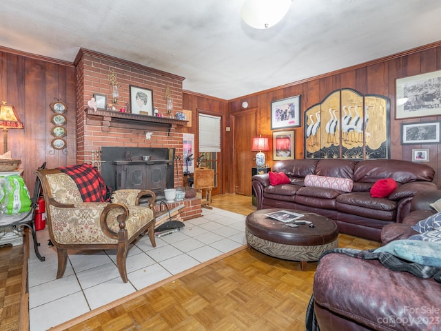 living room with wood walls, a brick fireplace, brick wall, and light tile patterned floors