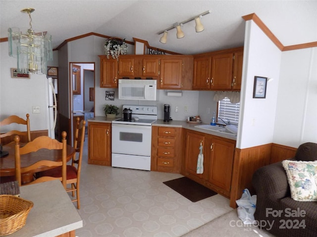 kitchen featuring white appliances, vaulted ceiling, a notable chandelier, track lighting, and light tile floors