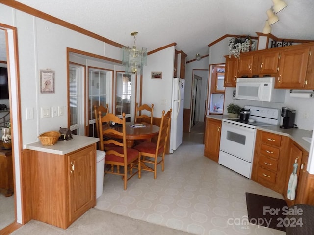 kitchen featuring lofted ceiling, white appliances, rail lighting, pendant lighting, and light tile floors