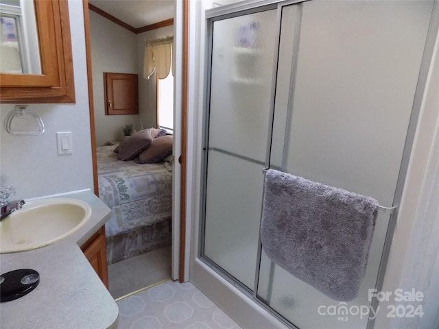 bathroom featuring a shower with shower door, tile flooring, and vanity