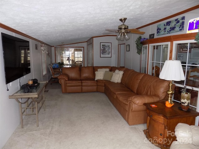 living room featuring ceiling fan, vaulted ceiling, a textured ceiling, and carpet floors