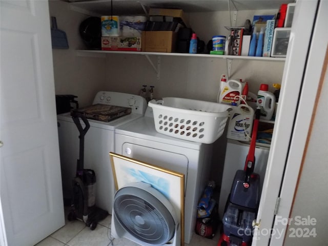 washroom featuring washing machine and dryer and light tile flooring