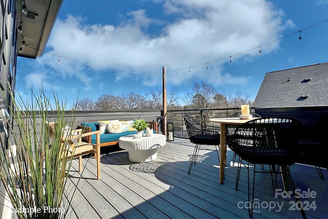 wooden terrace with an outdoor hangout area