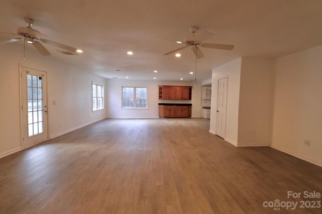 unfurnished living room featuring hardwood / wood-style floors and ceiling fan