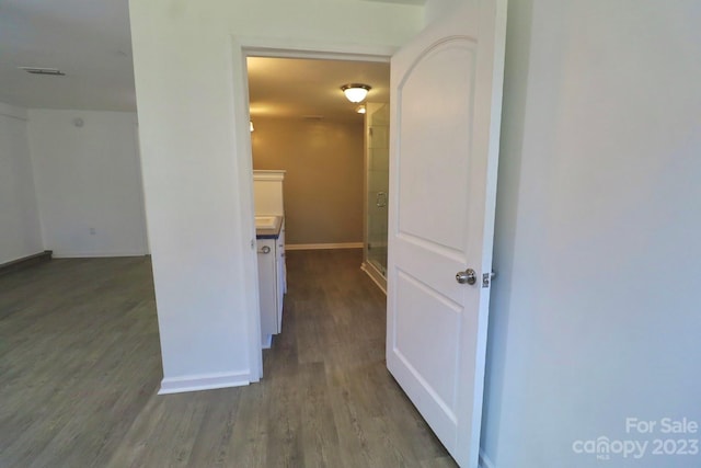 corridor featuring dark wood-type flooring