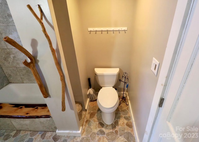 bathroom featuring toilet and tile flooring