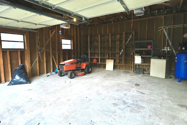 garage featuring refrigerator and a garage door opener