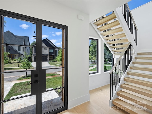 doorway to outside with french doors and light hardwood / wood-style flooring